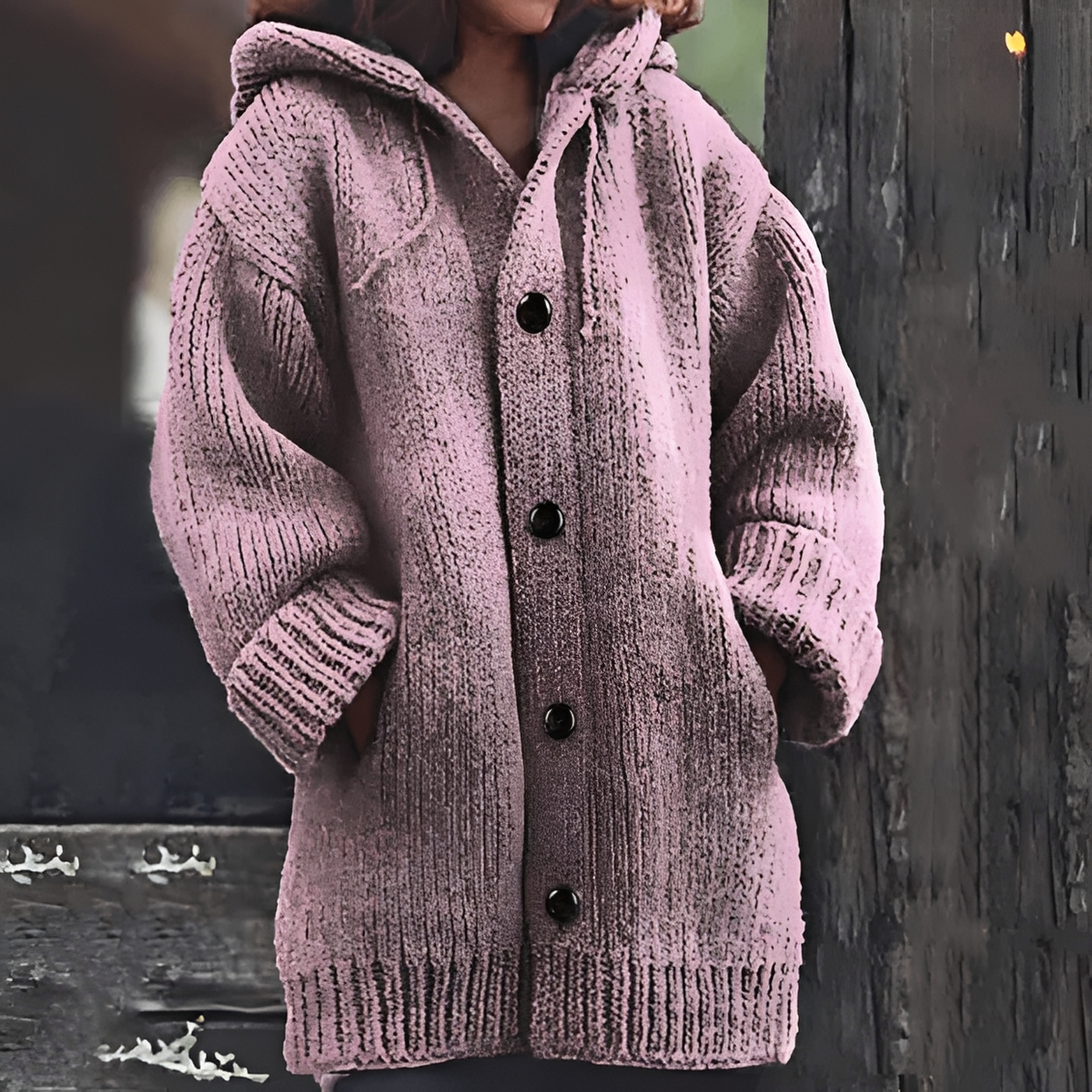 Dusty pink long cardigan with an attached hood, rounded front buttons, chunky knit texture, and ribbed cuffs.