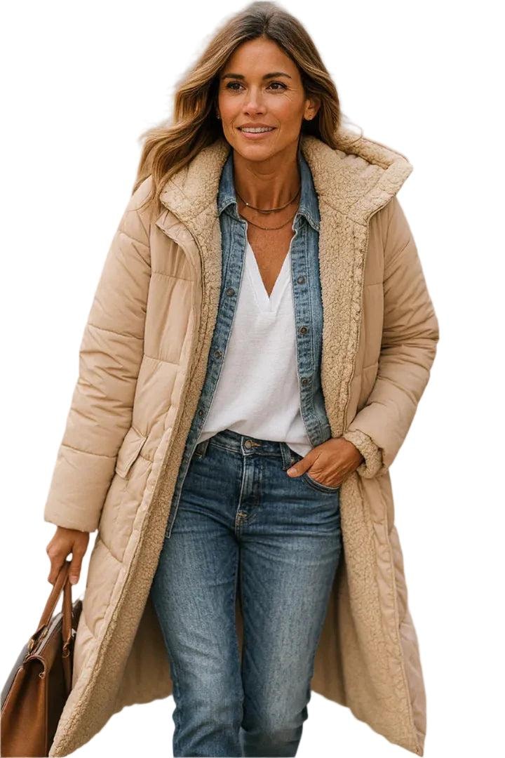 Close view of a beige long quilted coat showing the plush-lined hood, side pocket, long sleeves and open front.
