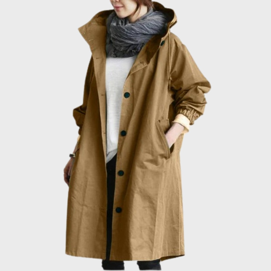 Front view of the rain coat in brown, showing the hood, vertical button fastening, and roomy side pockets.