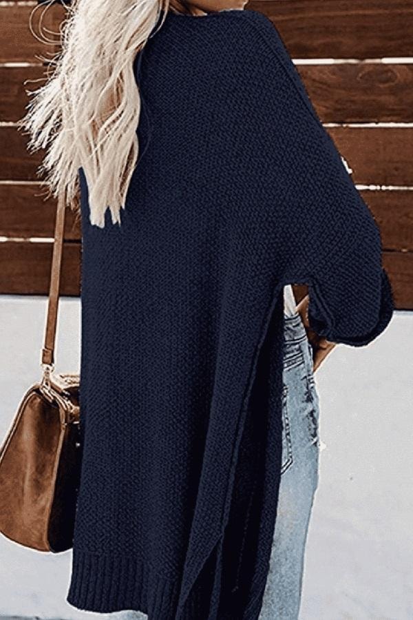 Back view of the navy cardigan highlighting its relaxed drape, long length, and ribbed lower hem.