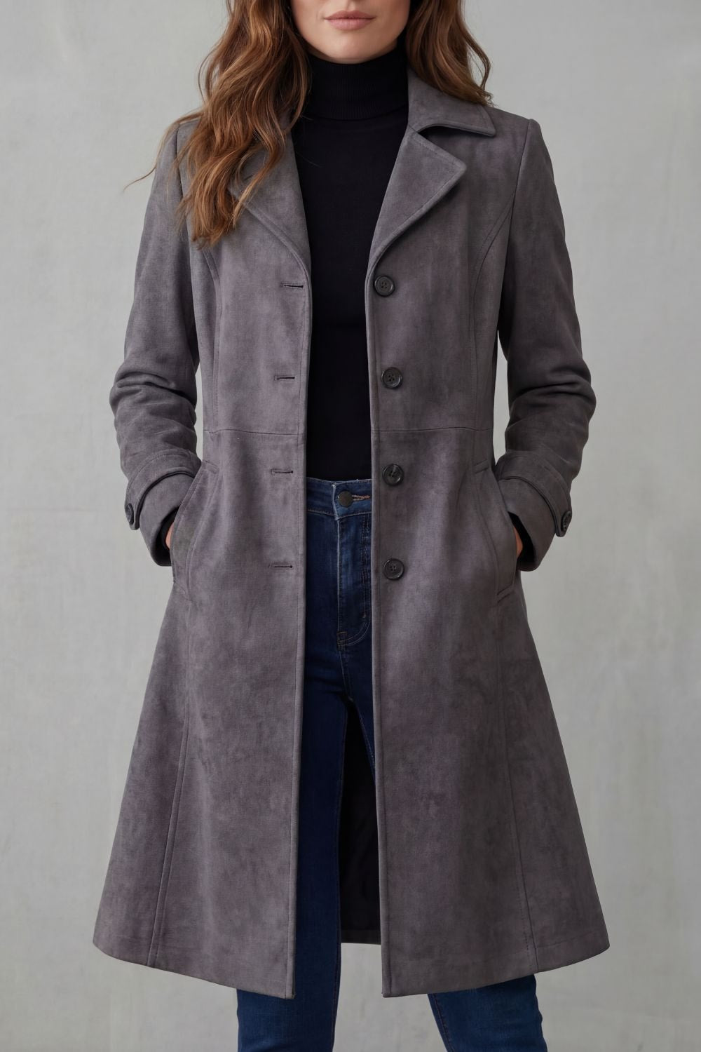 Front view of the gray longline coat, showing its tailored lapels, vertical button closure, practical pockets, and flared hem.