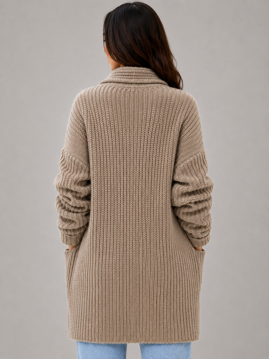 Back view of the taupe cardigan highlighting its longline coverage, soft draped collar, and relaxed sleeves.