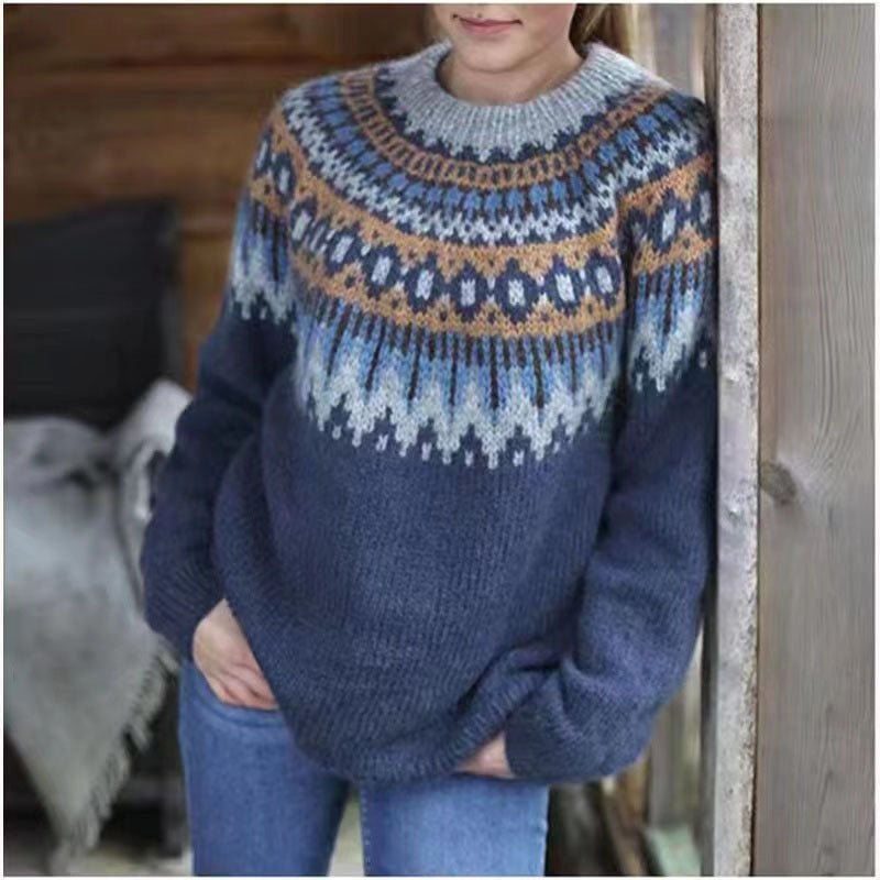 Navy crew neck sweater featuring a blue, white, and warm tan Nordic-inspired pattern across the shoulders and upper sleeves.