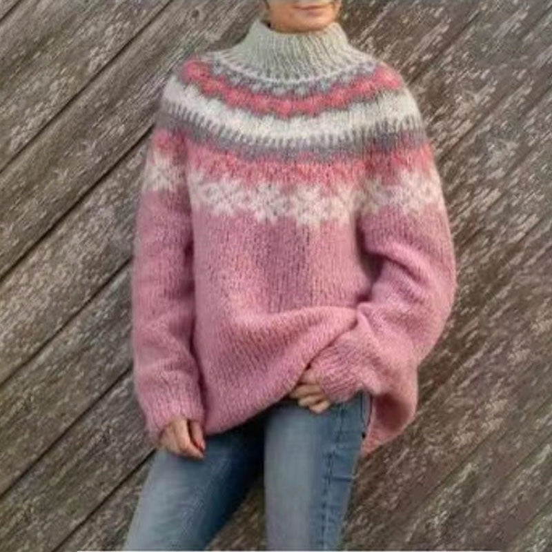 Pink relaxed-fit crew neck sweater with gray, white, and pink Nordic-inspired bands across the upper chest.