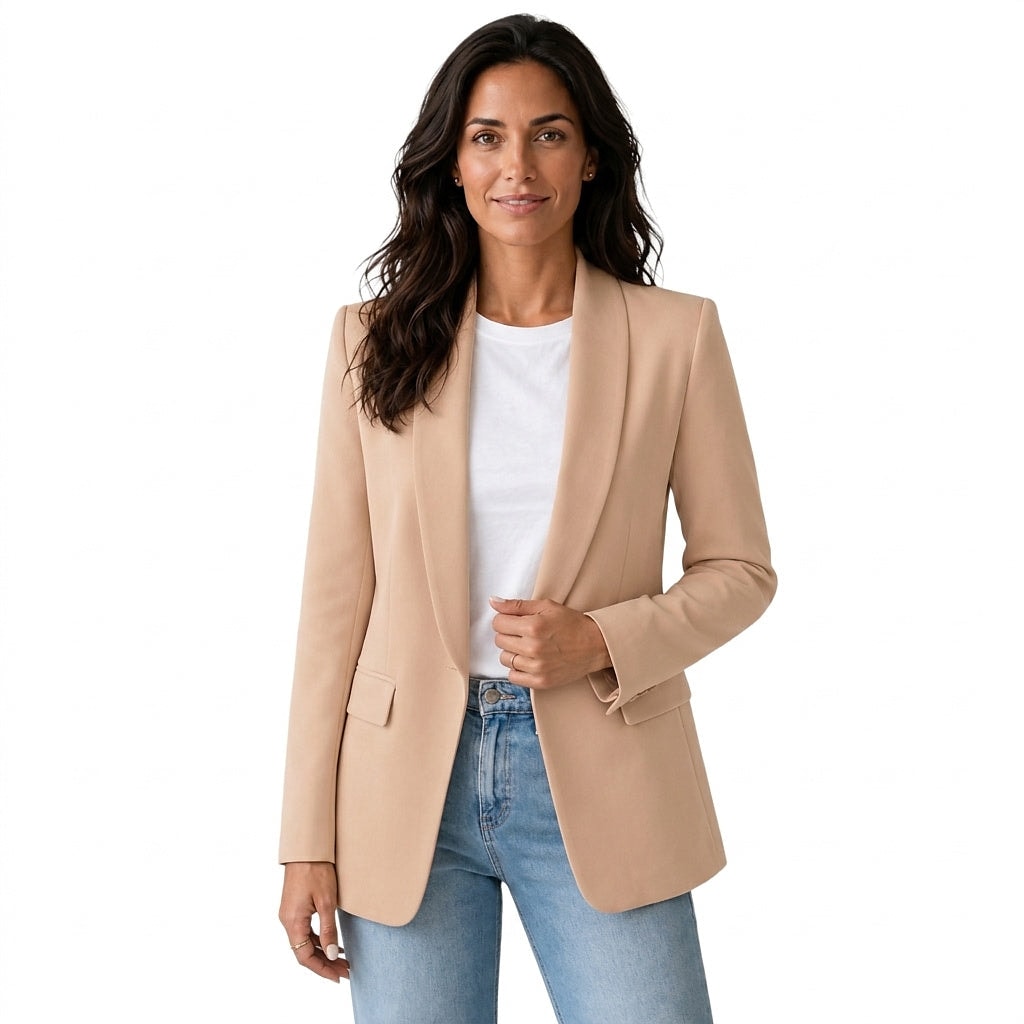 Front view of a tan open front blazer with shawl collar, long sleeves, and flap pockets, styled with a white top and jeans.