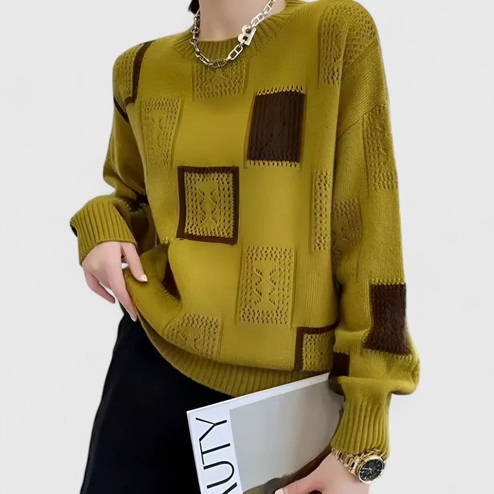 Mustard crew neck sweater shown from the opposite angle, revealing brown and openwork patchwork panels along the front and sleeve.