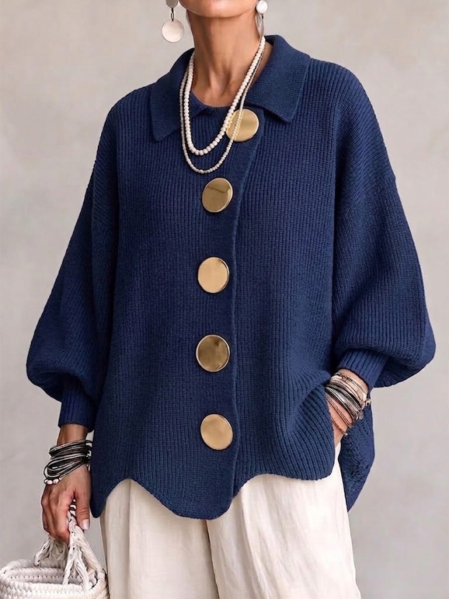 Navy oversized button-front cardigan with five large round buttons, pointed collar, balloon sleeves, ribbed cuffs, and gently curved hem.