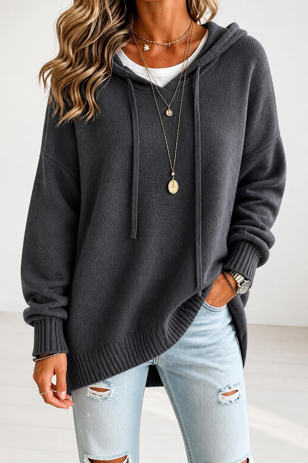 Front view of the oversized hooded sweater in charcoal gray with long drawstrings and a relaxed fit.
