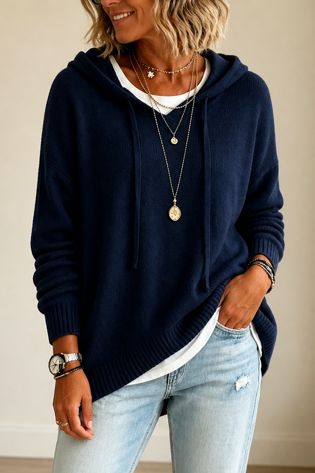 Front view of the oversized hooded sweater in deep navy with a longer hem and relaxed sleeves.