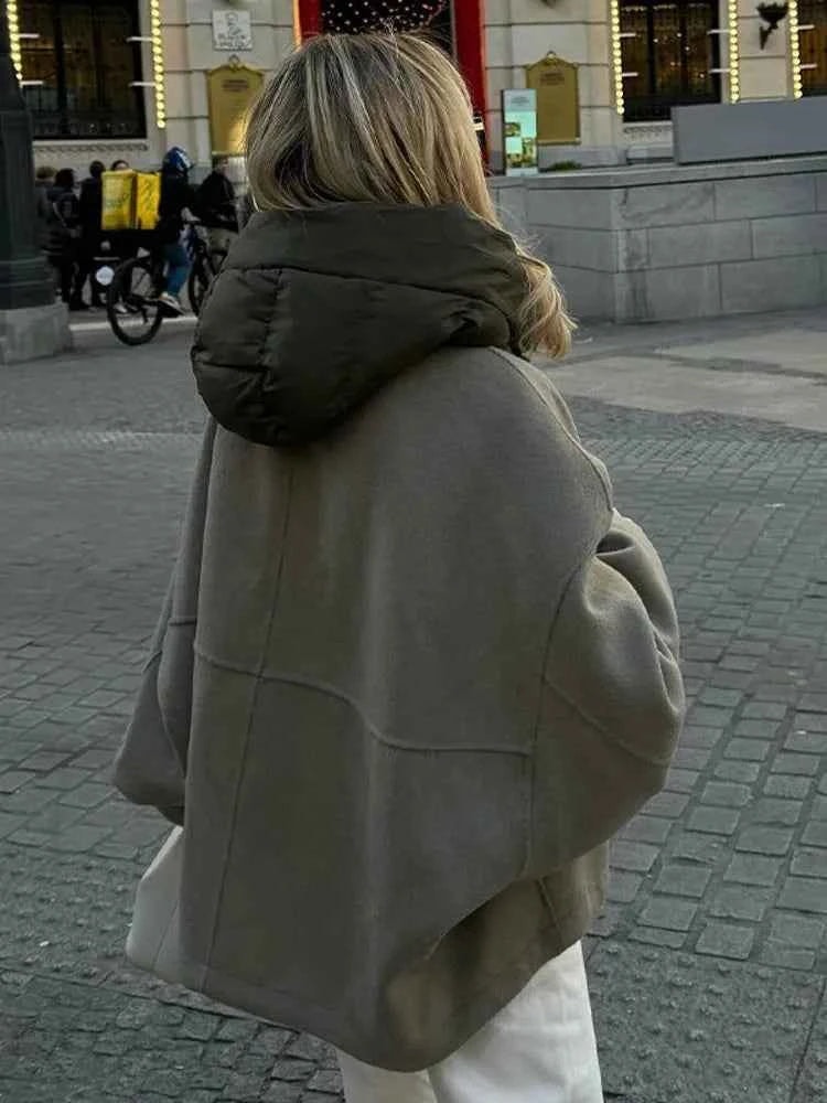 Back view emphasizing the jacket's roomy hip-length cut and quilted hooded collar.