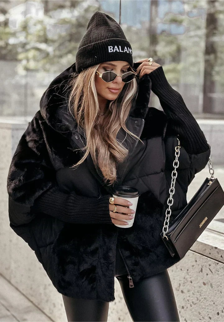 Black oversized hooded puffer jacket featuring contrasting plush sections, a roomy silhouette and ribbed cuffs.
