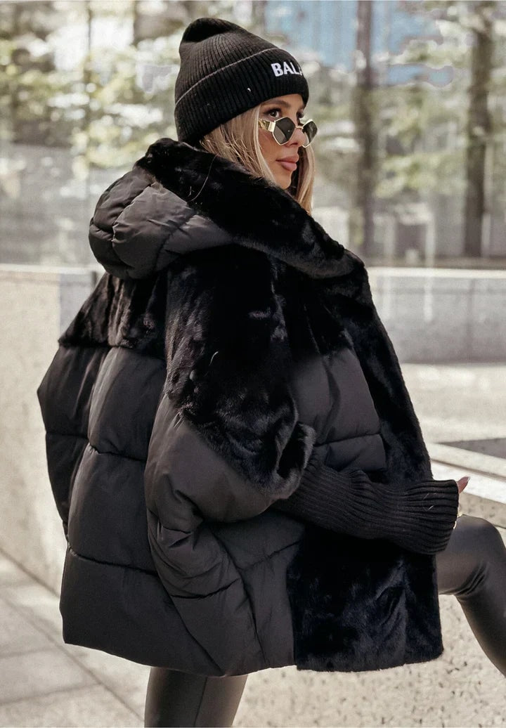 Back and side view of the black hooded puffer jacket showing its quilted panels, plush hood and relaxed oversized shape.