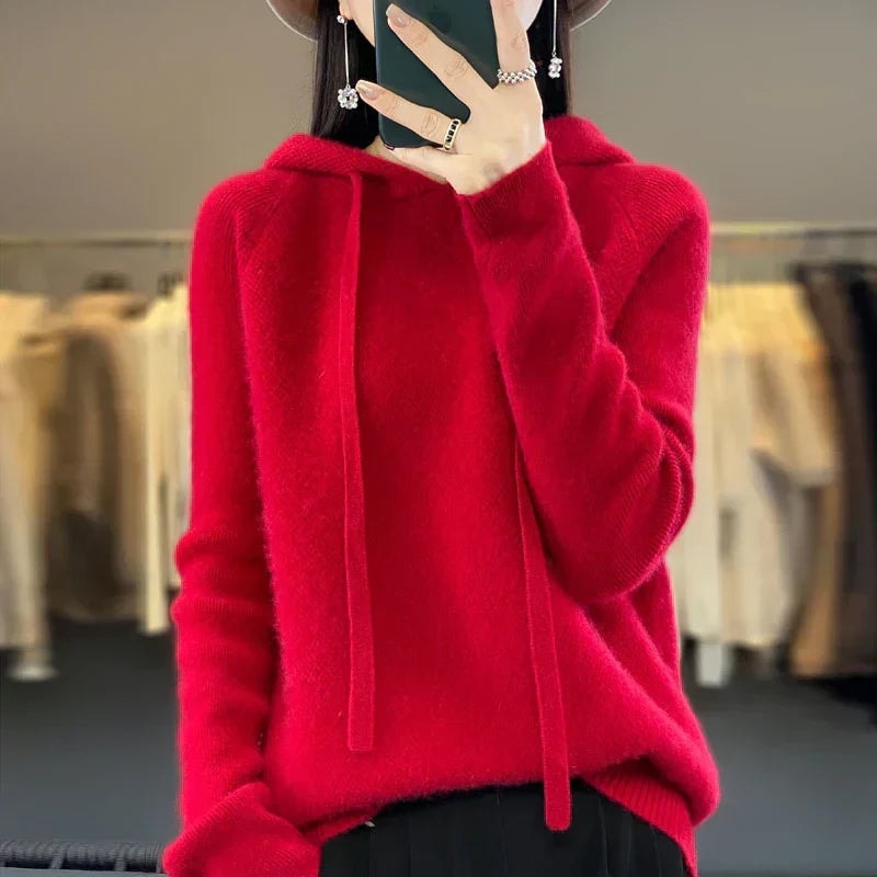 Bright red oversized knit pullover hoodie featuring a hood, extended drawstrings, and long sleeves.