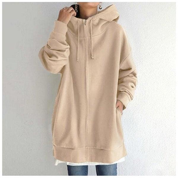 Front view of the oversized longline zip-up hoodie in beige, worn over a white top with the hood and front zip centered.