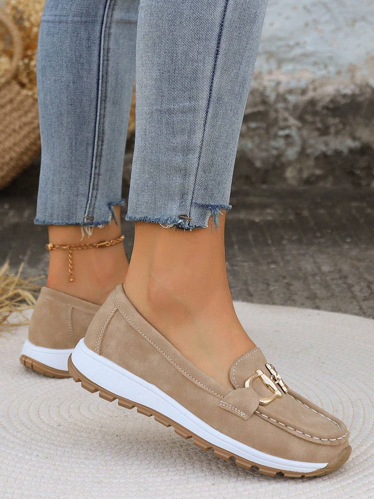 Rear three-quarter view of beige platform loafers showing the slip-on heel shape and layered white and brown outsoles.