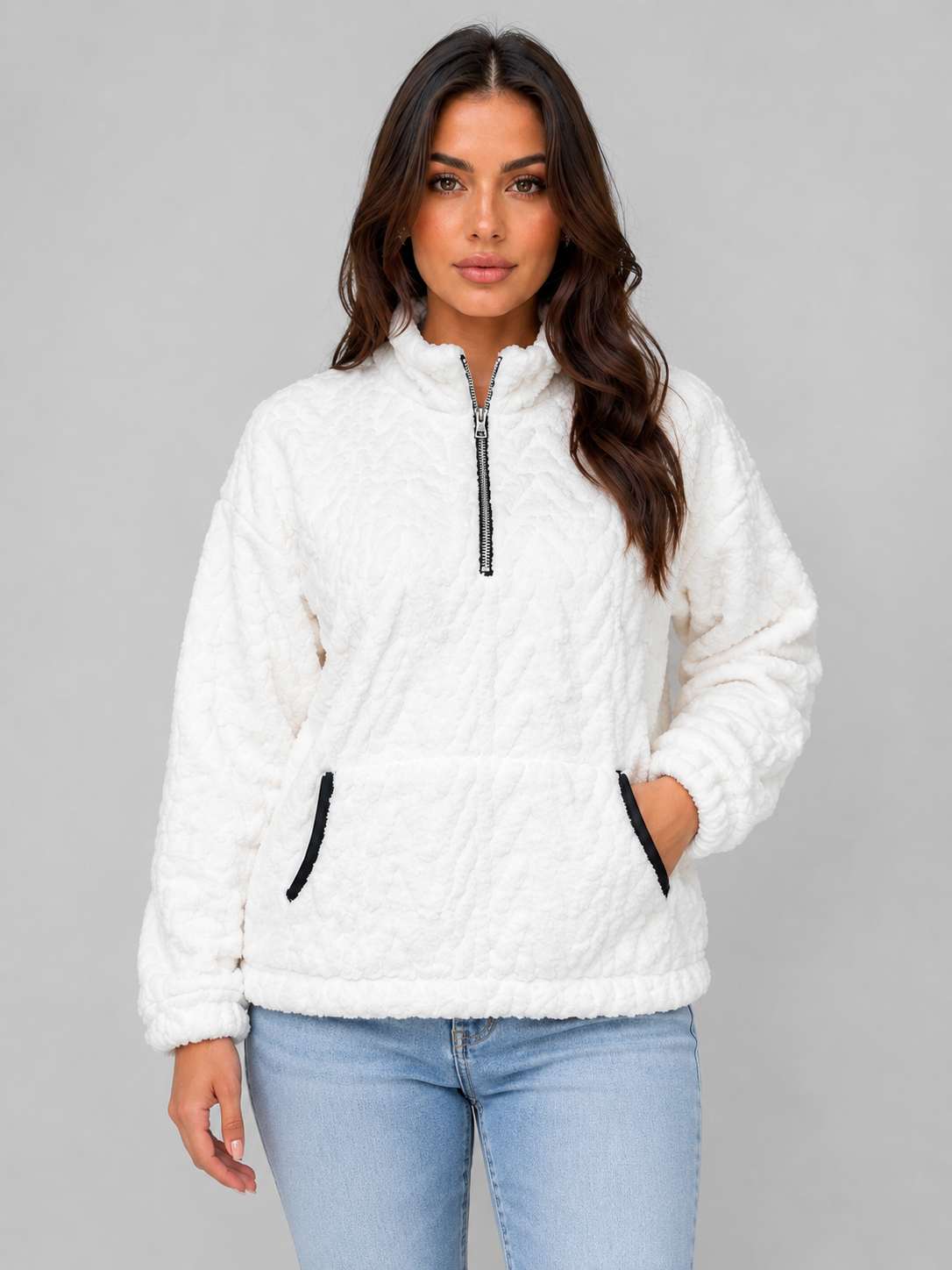 White plush half-zip pullover with a high neckline, kangaroo pocket, and elasticated cuffs, shown from the front.