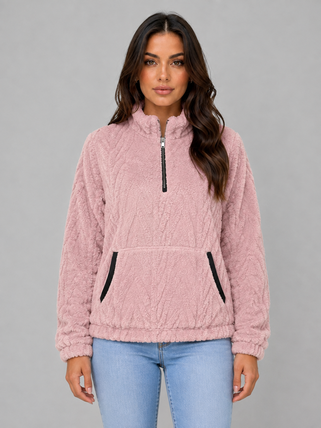 Pink plush half-zip pullover shown from the front, featuring a high neckline and roomy kangaroo pocket.