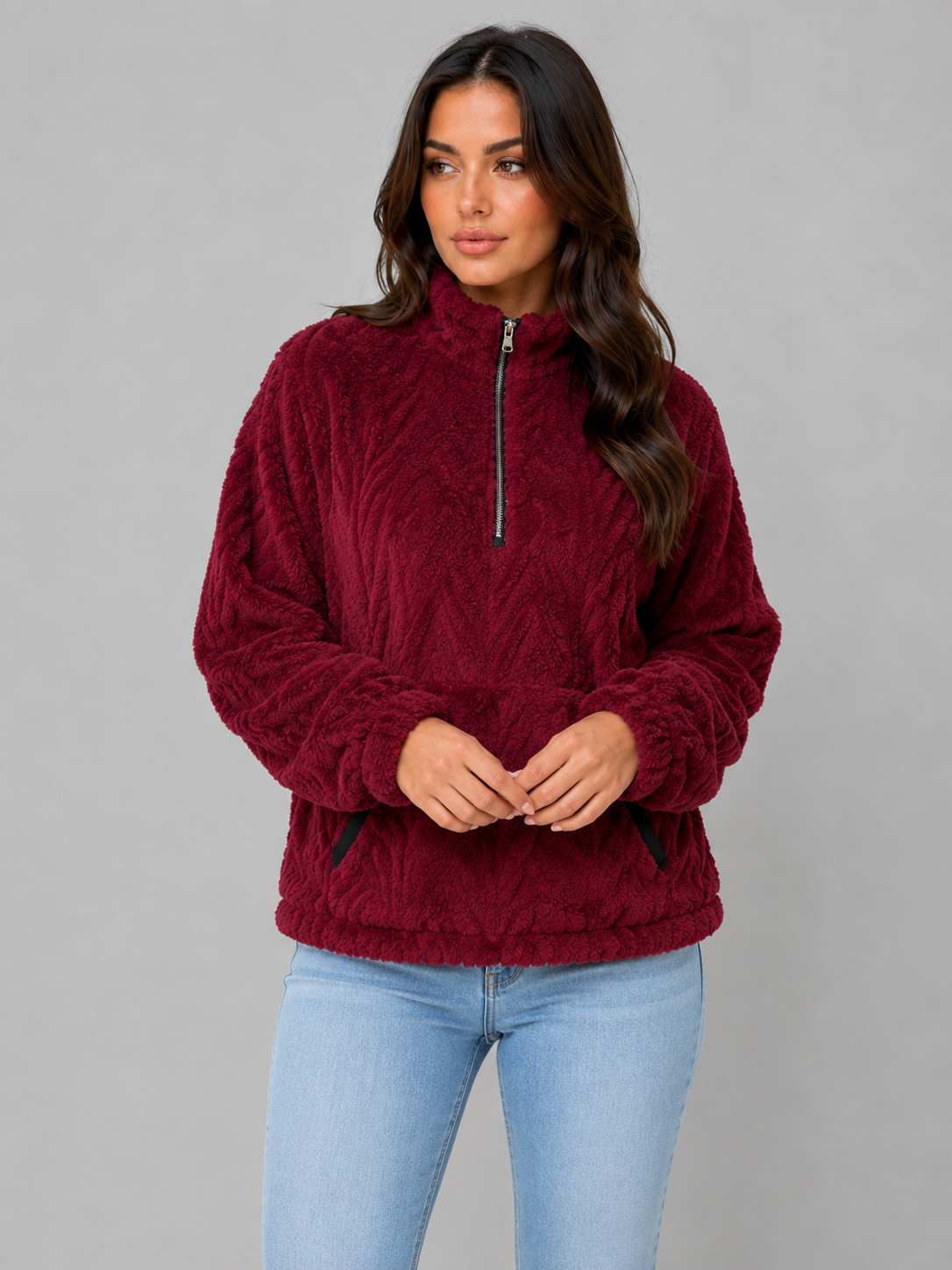 Deep burgundy plush half-zip pullover shown with the zipper partially open and the sleeves gathered at the cuffs.