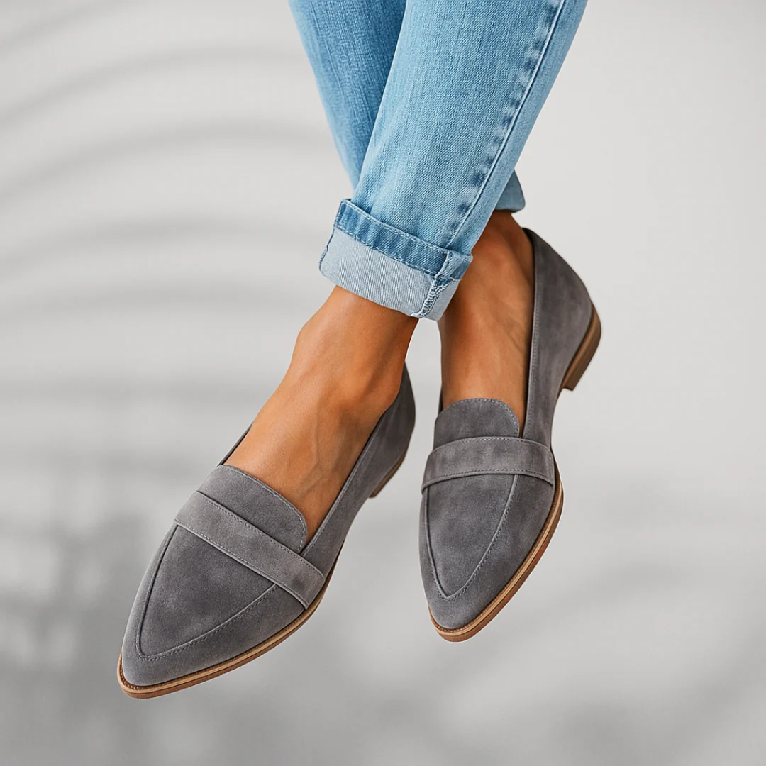 Gray pointed toe slip-on loafers shown from an angled front view with layered detailing across the uppers.