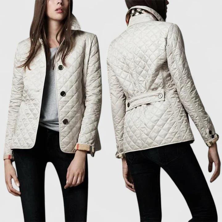 Front and back views of a light-colored quilted jacket, highlighting the button front, pointed collar, back waist tab, and cuff buttons.