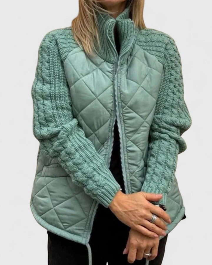 Mint green quilted jacket with textured sleeves shown partially open, featuring a high collar and side pockets.
