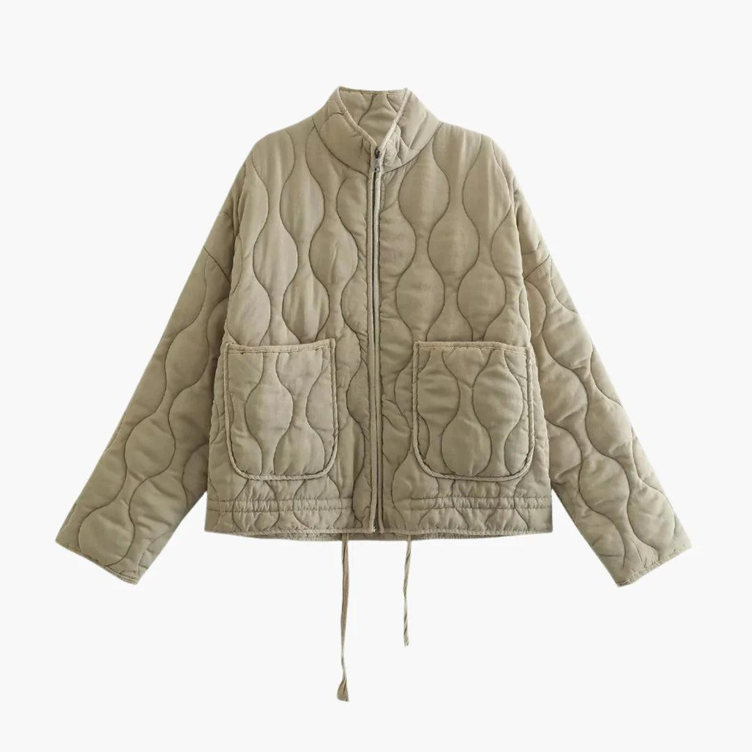 Front view of the short quilted jacket in a muted olive shade, highlighting the wavy quilting, stand collar, zip closure, and two patch pockets.
