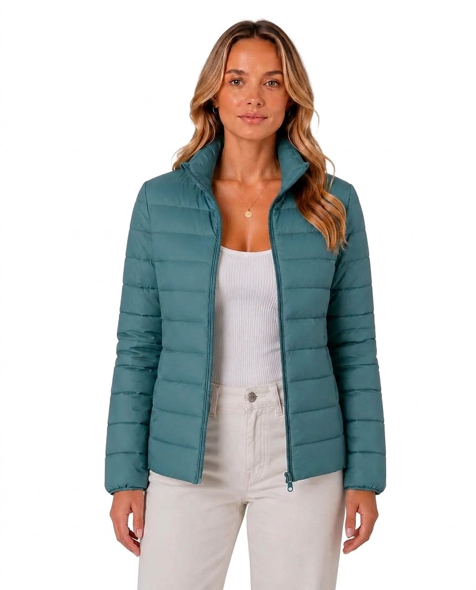 Front view of a teal quilted jacket worn open, showing the stand collar, long sleeves, and full front zipper.