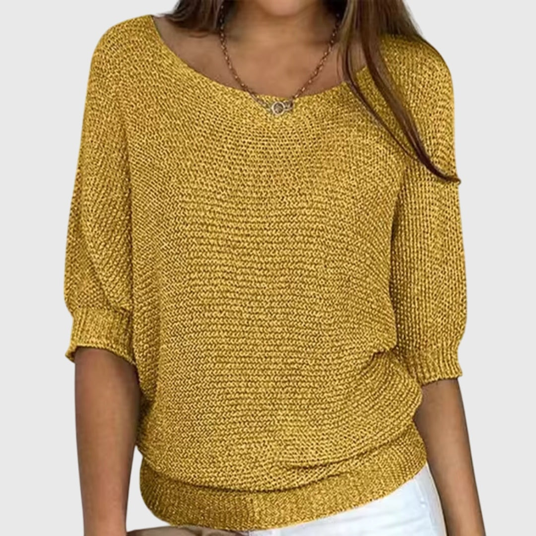 Mustard yellow sweater with an easy silhouette, three-quarter sleeves, and ribbed edging.