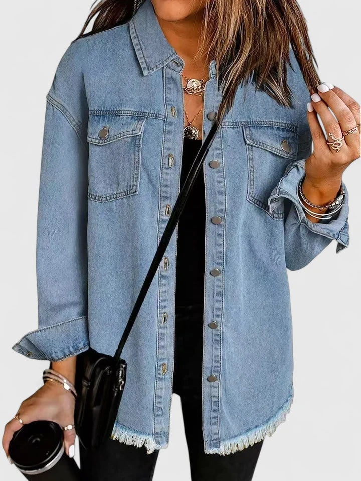Light blue relaxed jacket worn over black clothing, highlighting the front button row and two flap chest pockets.