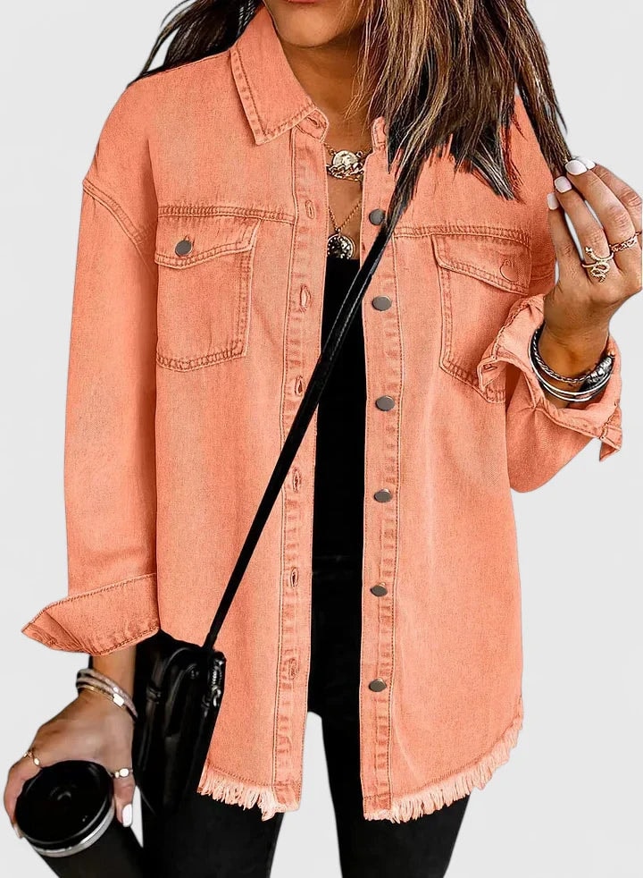 Peach-colored trucker jacket featuring a row of front buttons, two flap pockets, and a raw hem.