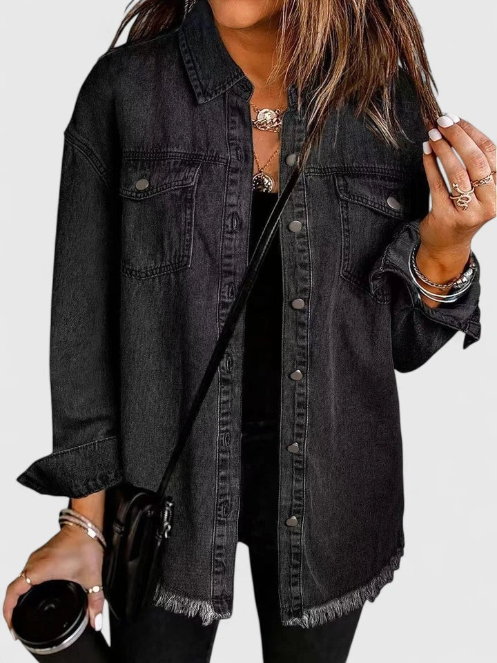 Black trucker jacket with a classic pointed collar, button closure, two chest pockets, and a rugged frayed hem.