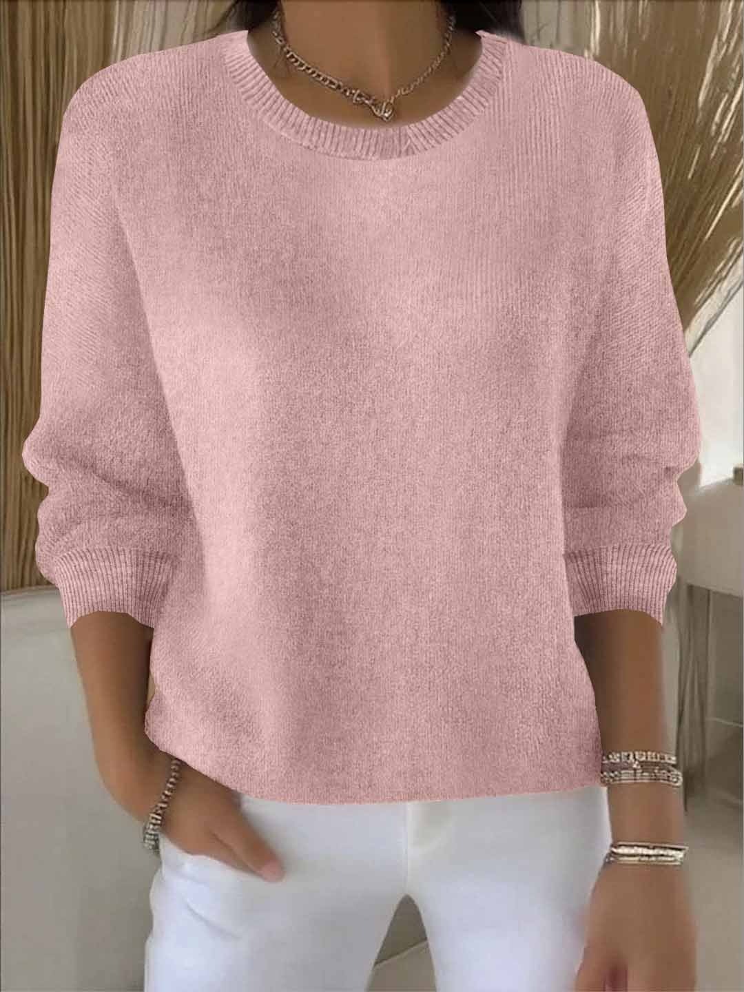 Soft pink relaxed-fit sweater with a classic crew neckline, long sleeves, and ribbed trim at the cuffs and hem.