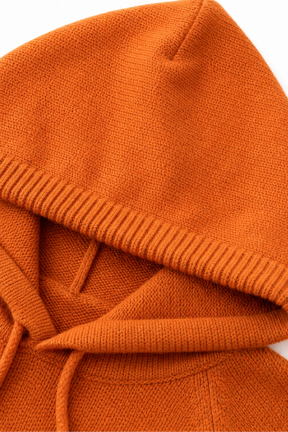 Close-up of the orange pullover hood showing its ribbed edge and drawstring channel.