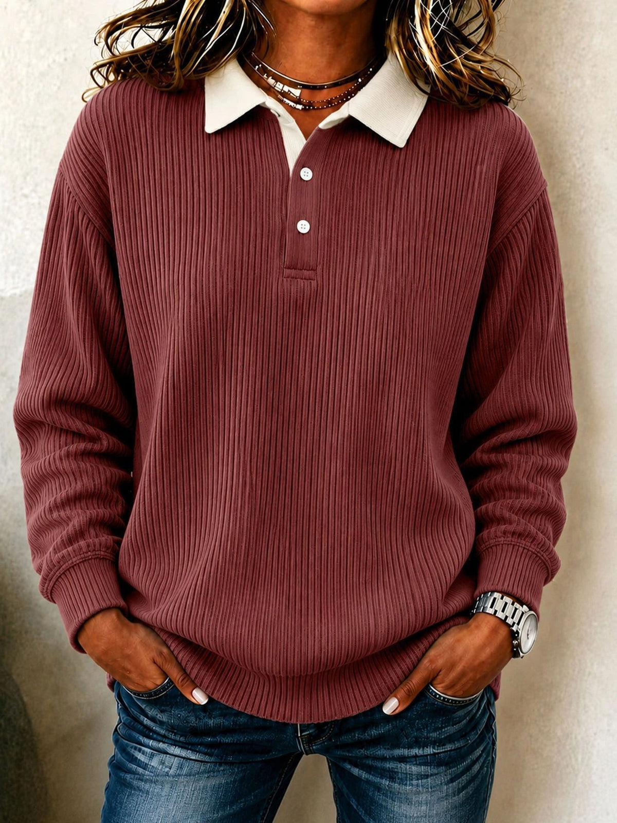 Burgundy ribbed long-sleeve polo sweater with a cream collar, short button placket, and ribbed cuffs.