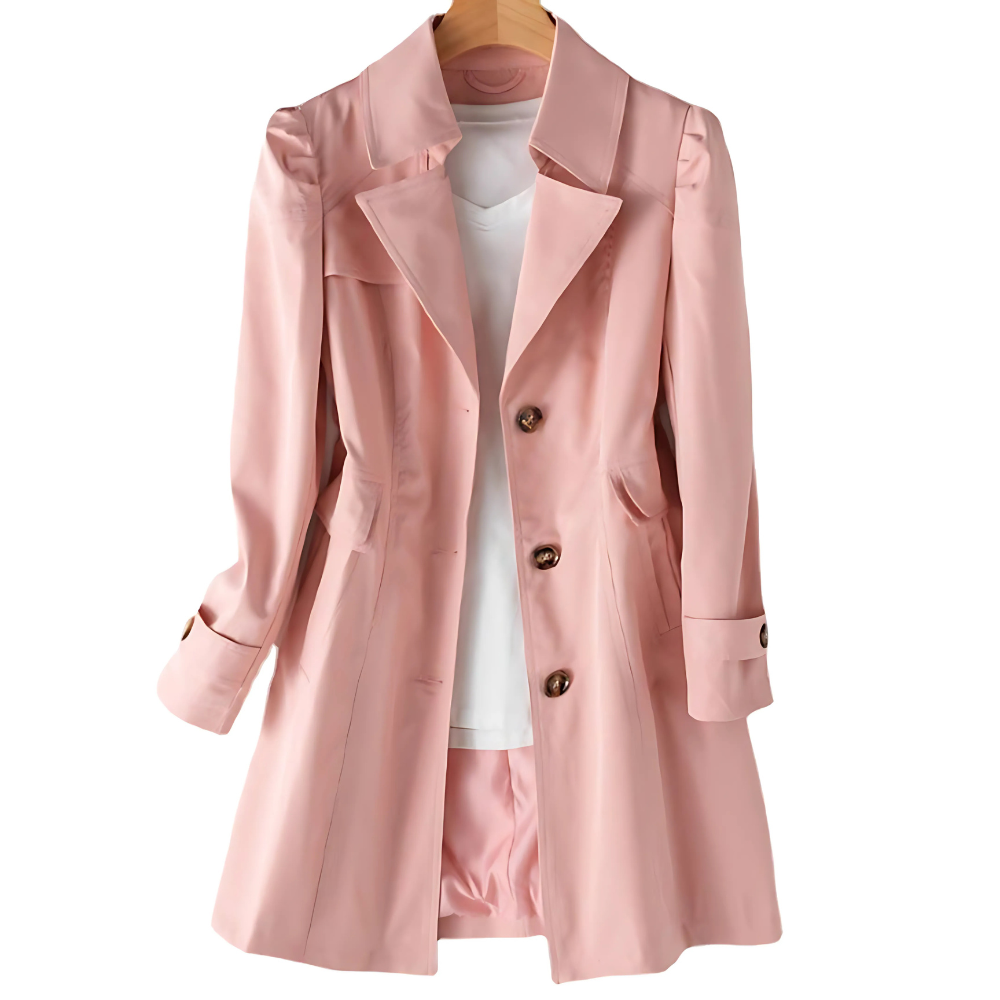 Pink version of the mid-length trench coat on a hanger, showing its structured notched lapels, three-button front, side pockets, and adjustable sleeve cuffs.