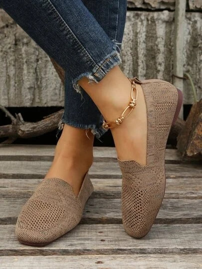 Taupe open-knit square-toe flats styled with cropped jeans in a side view, showing the low flat soles.