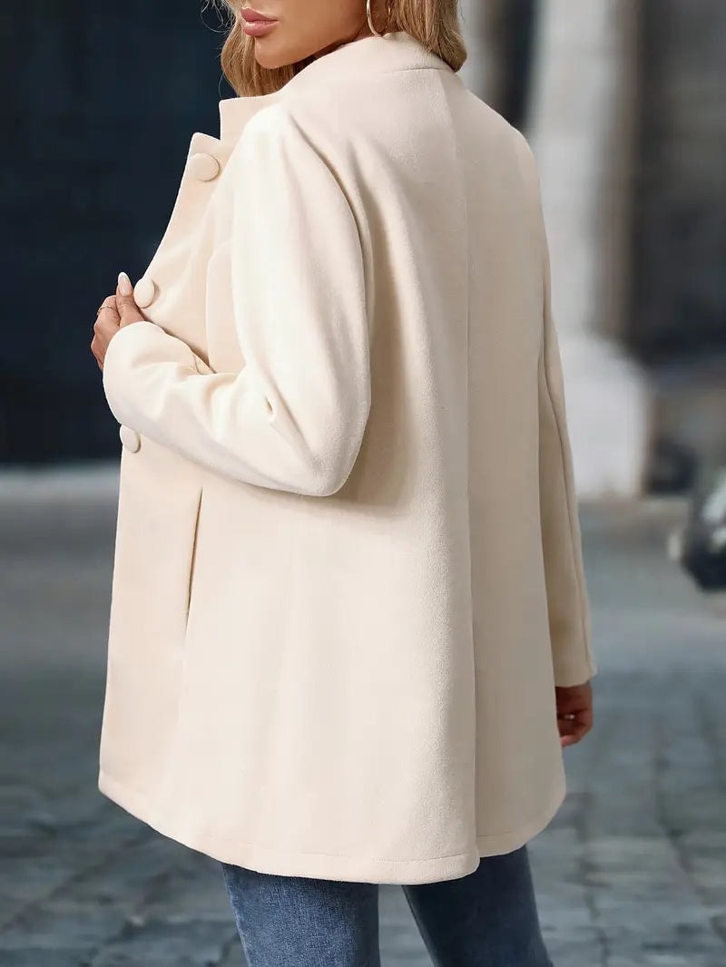 Rear three-quarter view of the ivory coat, showing its smooth back and thigh-length hem.