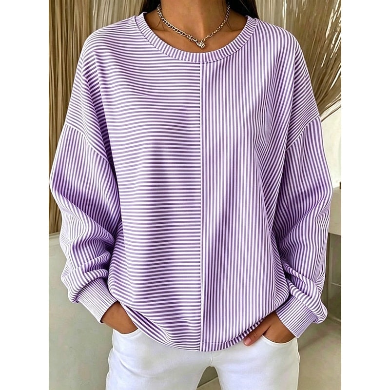 Front view of a purple and white striped crew neck sweatshirt with contrasting horizontal and vertical stripe panels, a relaxed silhouette, dropped shoulders, and ribbed sleeve cuffs and hem.