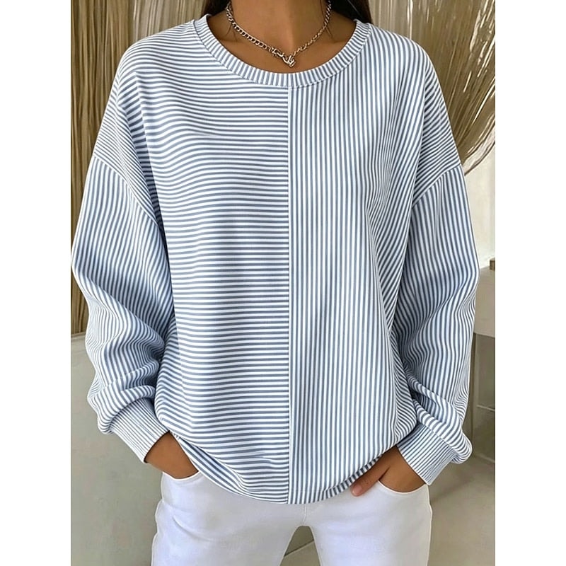 Front view of a light blue and white striped sweatshirt with wavy horizontal stripes on the left front and vertical stripes on the right, finished with a classic crew neckline and ribbed cuffs.