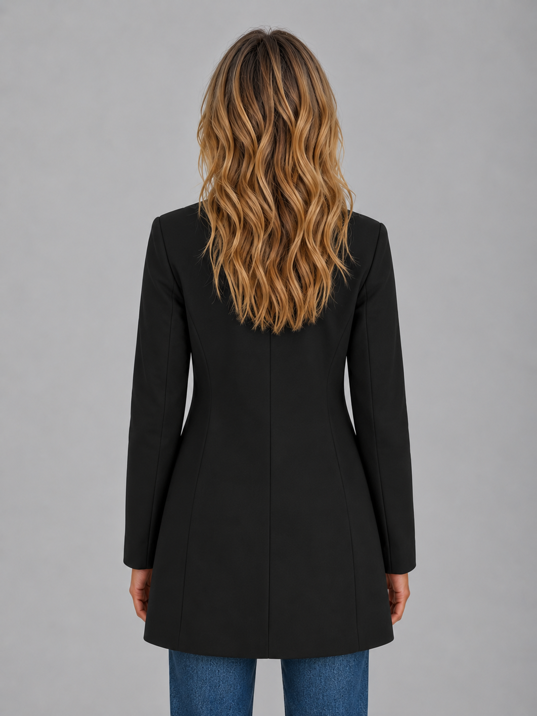 Back view of the black longline coat, showing the sleek silhouette, center back seam and gently flared hem.