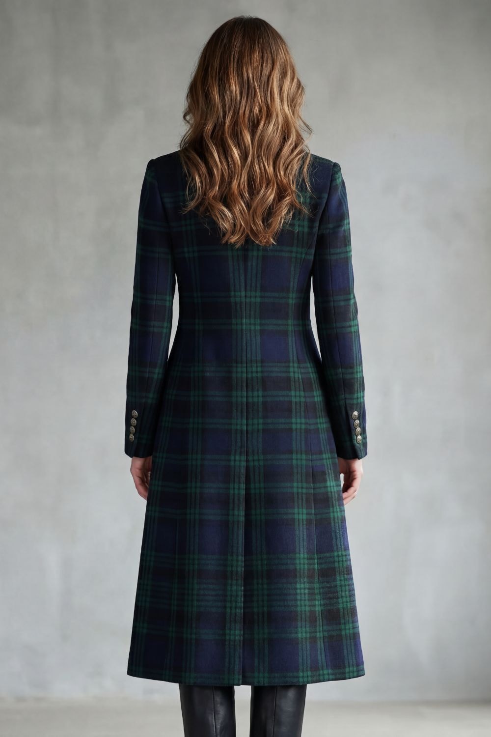 Back view of the longline coat highlighting the continuous tartan check pattern and tailored, elongated shape.