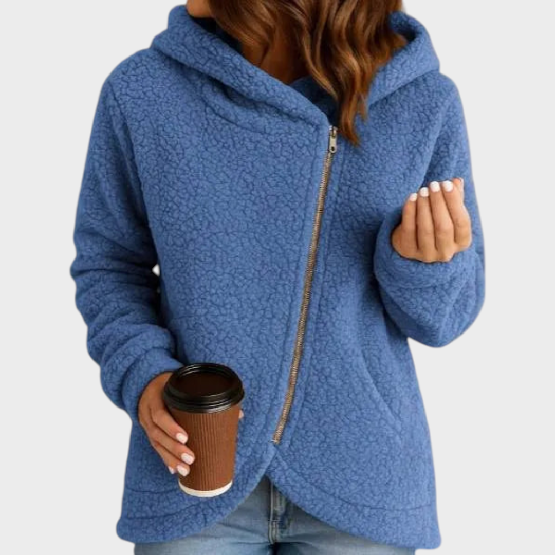 Blue teddy textured hooded jacket shown from the front, featuring an oversized hood, long sleeves, and a diagonal zip fastening.