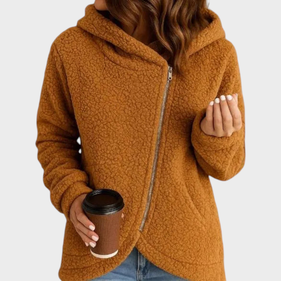 Rust-brown teddy hooded jacket displaying its textured finish, long sleeves, curved hem, and diagonal front zipper.