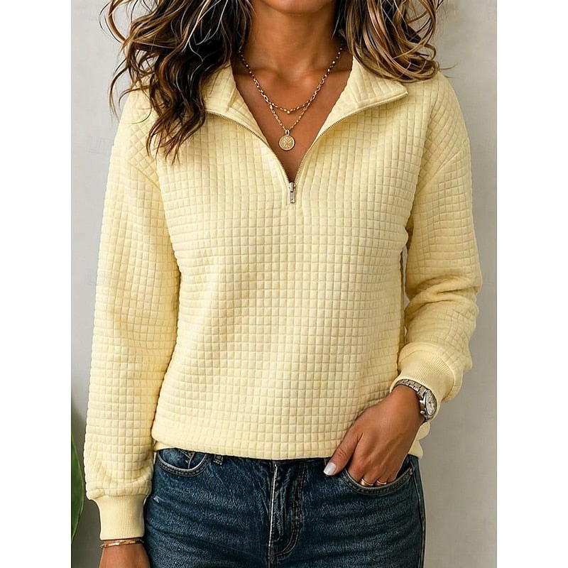 Pale yellow textured quarter-zip pullover shown from the front with its collar open and sleeves extending to ribbed cuffs.