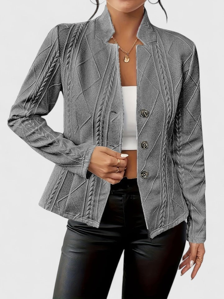 Gray textured blazer showing its dimensional geometric pattern, tailored shape, and three-button closure.