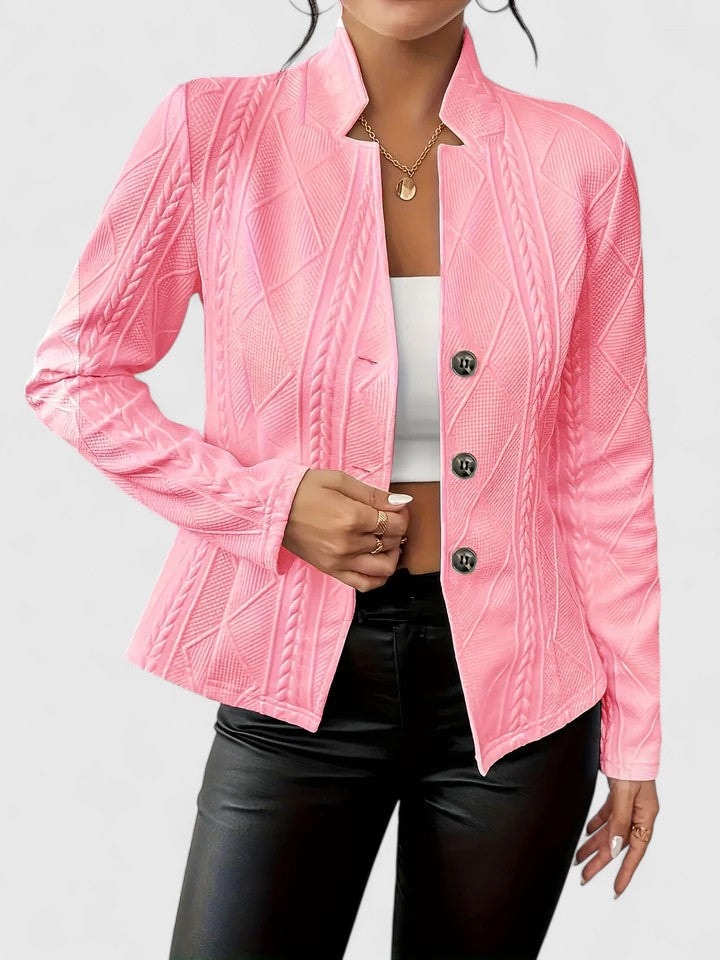 Bright pink single-breasted blazer with a notched collar and long sleeves styled over a white top.