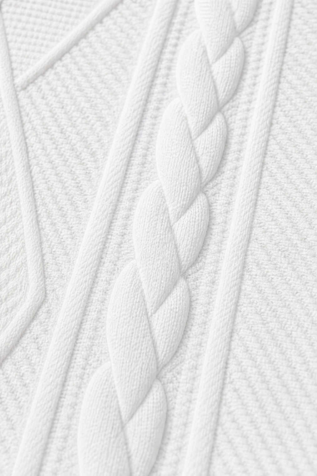 Detailed close-up of the raised braided cable pattern running through the blazer’s textured surface.