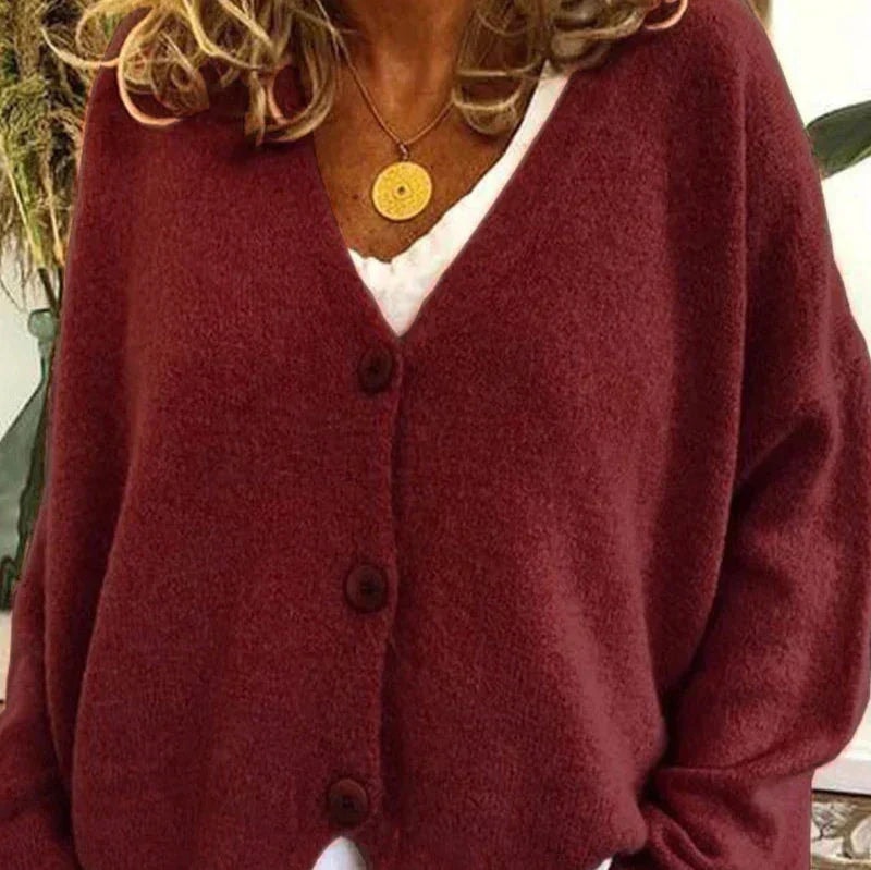 Deep burgundy V-neck cardigan displaying its relaxed shape, long sleeves, and front buttons.