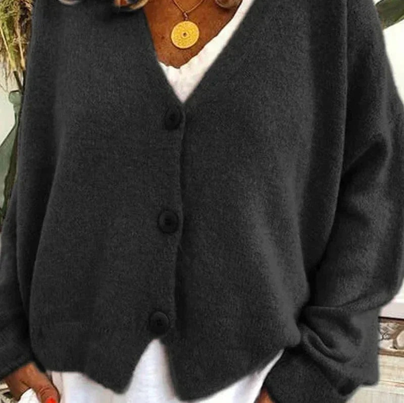 Black V-neck button-front cardigan shown in a close view with long sleeves and a relaxed silhouette.