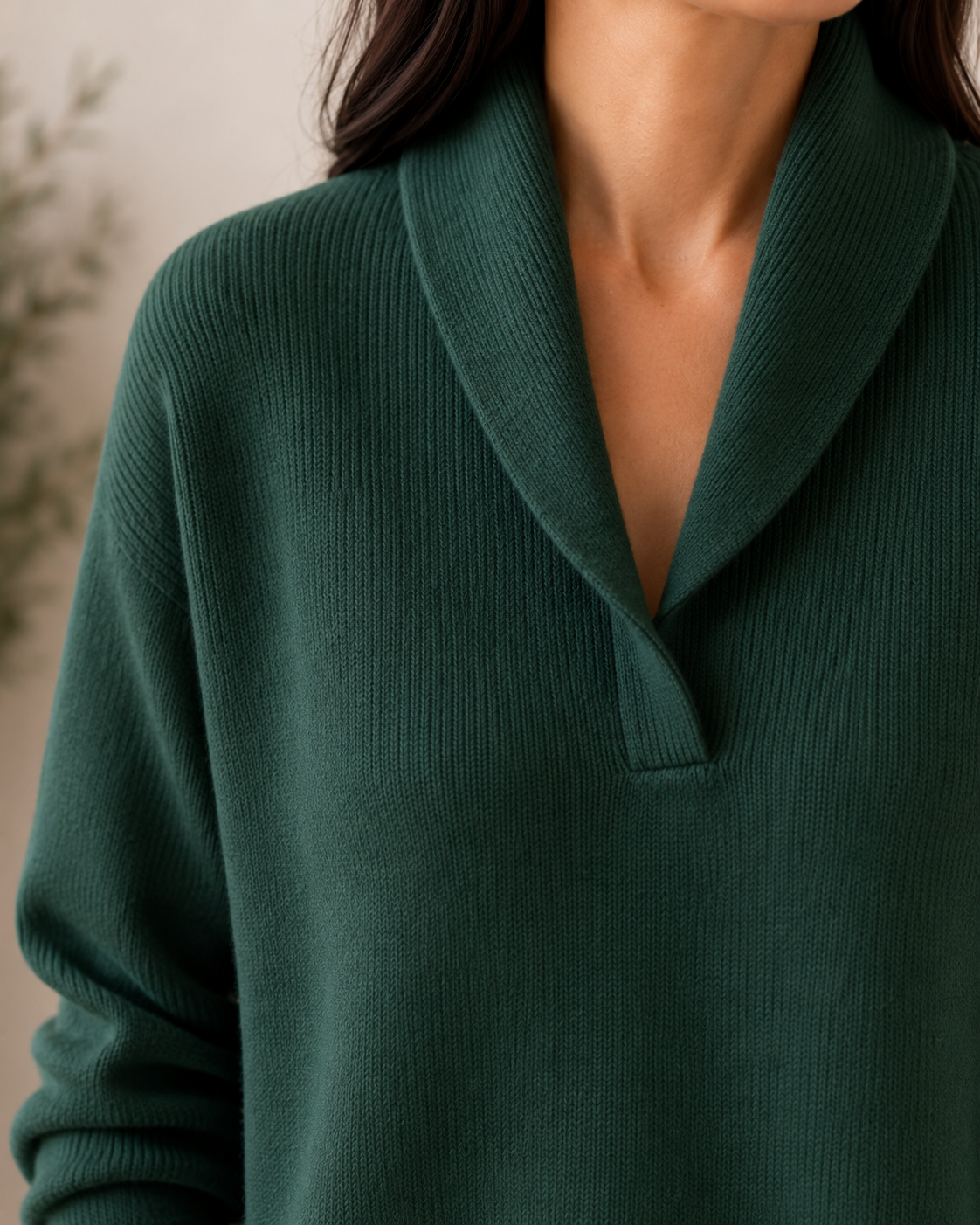 Close-up of the dark green sweater’s V-neckline and wide shawl collar.